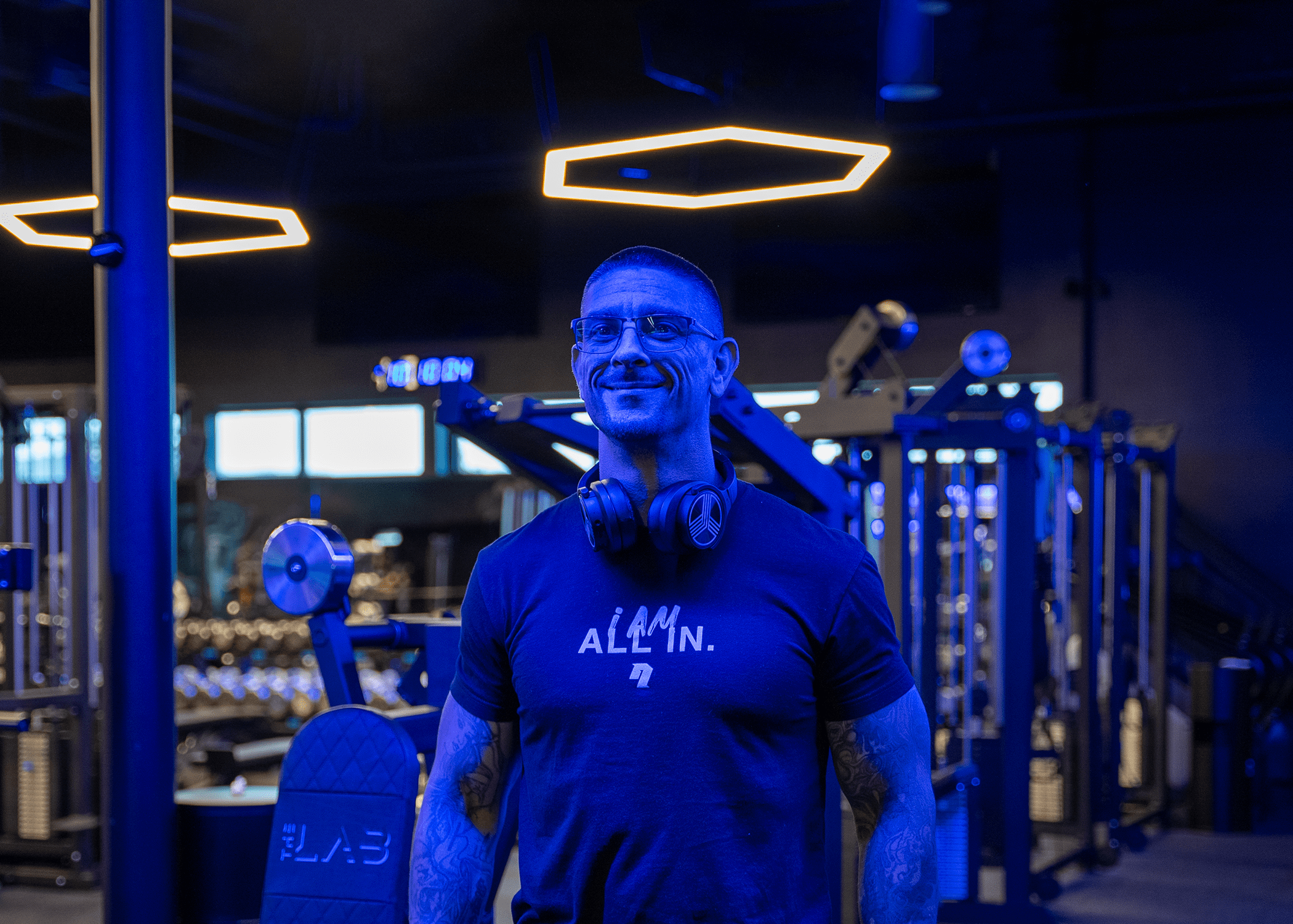 Coach Paul standing under a blue light